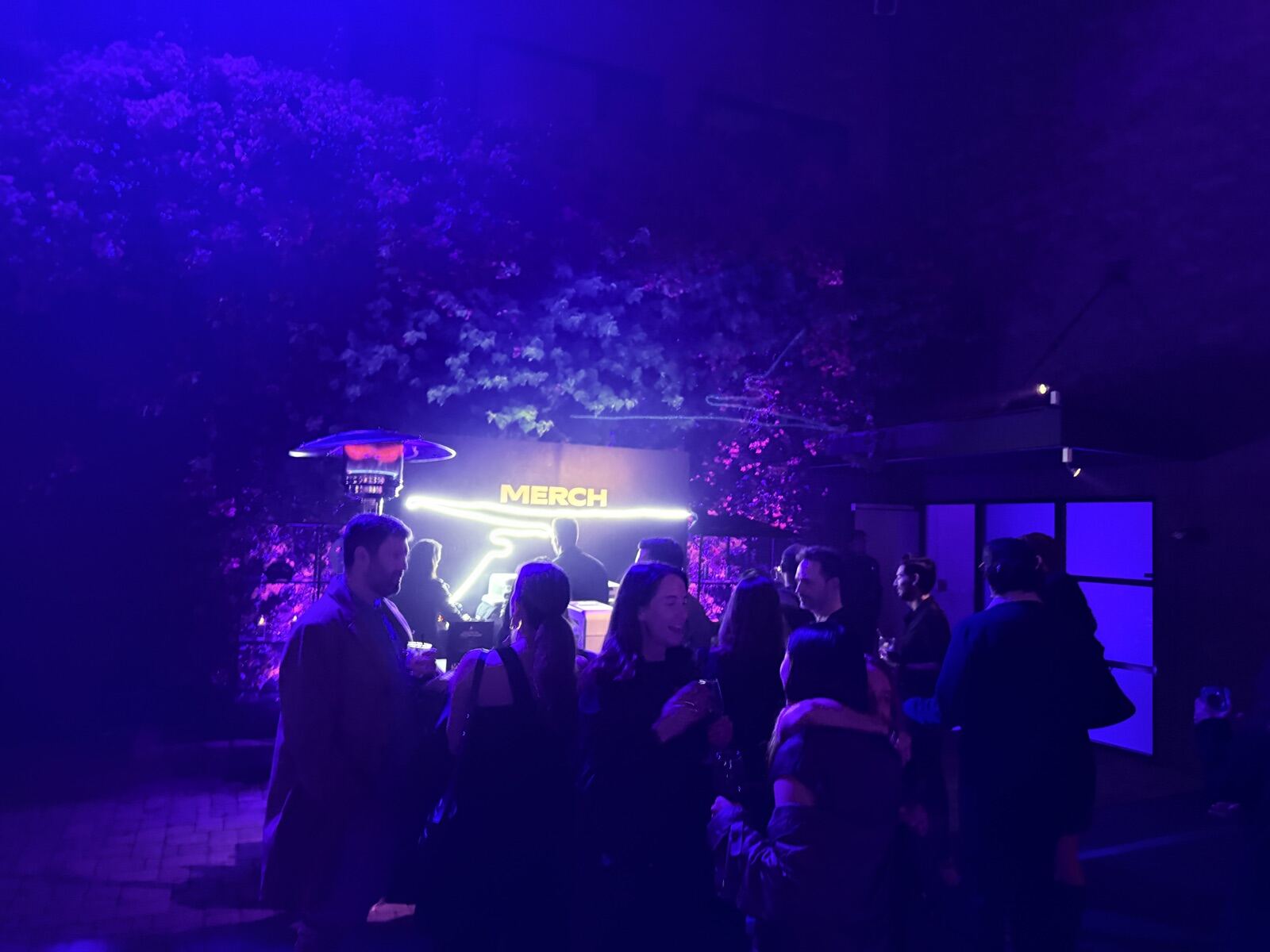 Wide view of a Merch Troop on-site swag printing booth serving a crowd