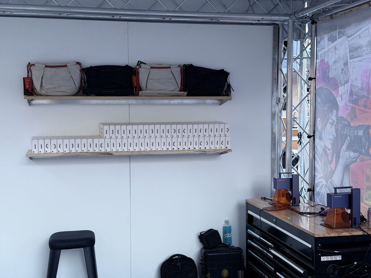 Shelf of branded merch and hard goods staged at an on-site swag station