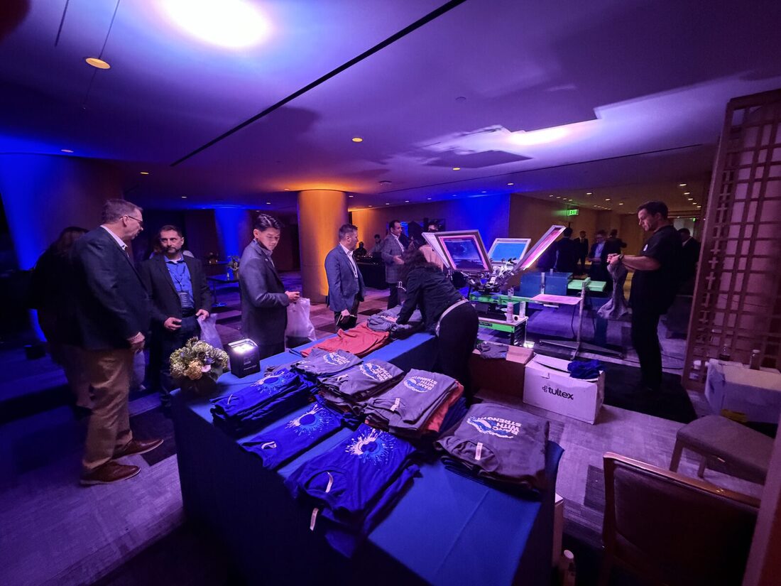 Lounge-style merch display of finished swag at a corporate event